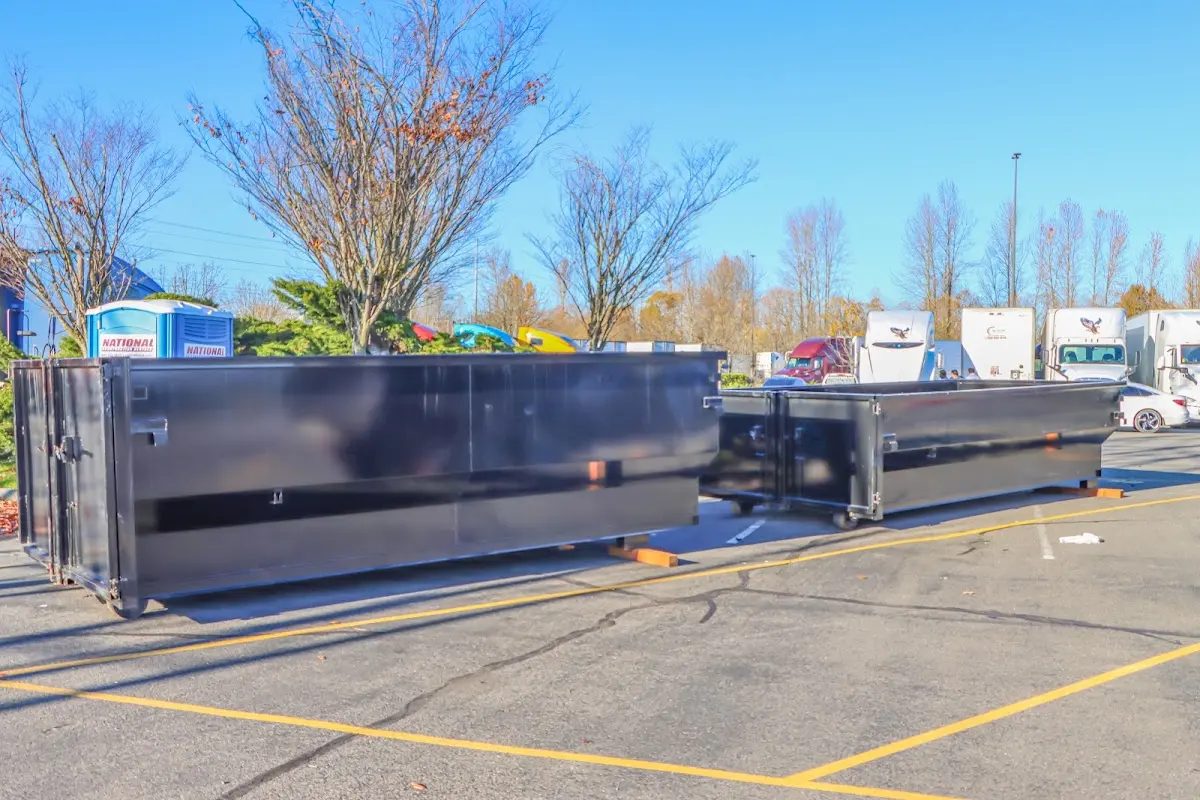 Professional dumpster rental service with roll-off container on residential driveway in Rhinebeck